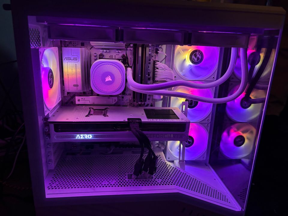 A finished Amprix custom PC with a white case and purple lighting